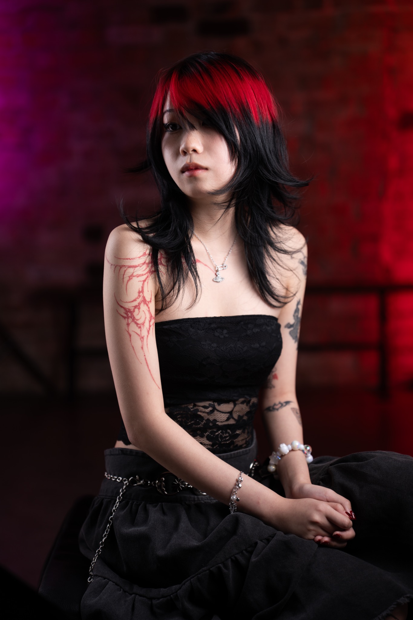 Bethia black layered haircut with vivid red accents