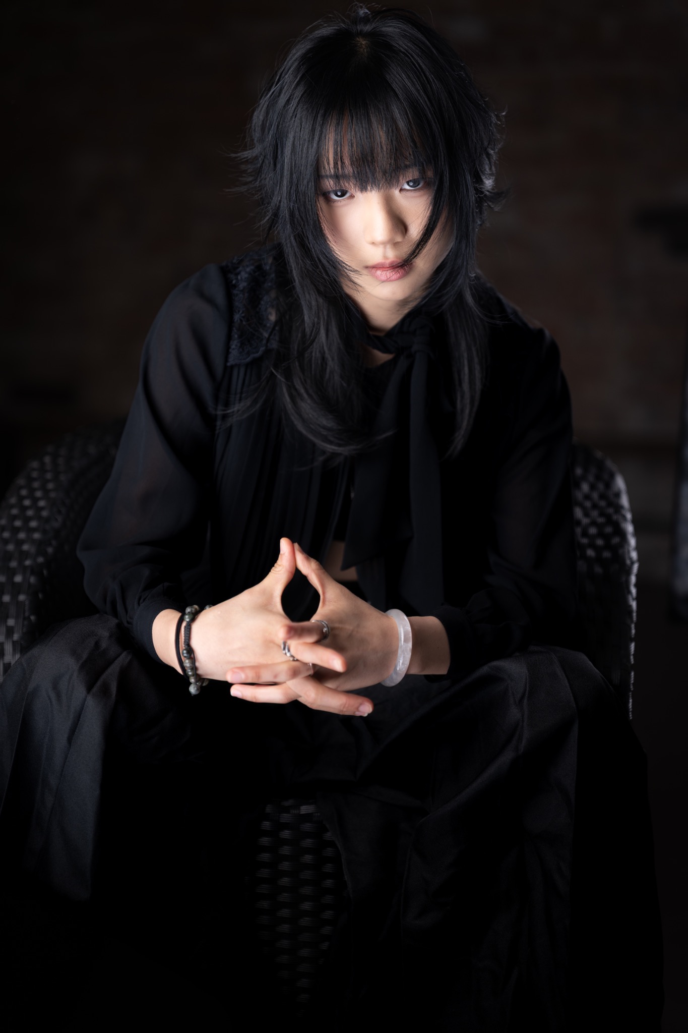 Black layered haircut seated portrait