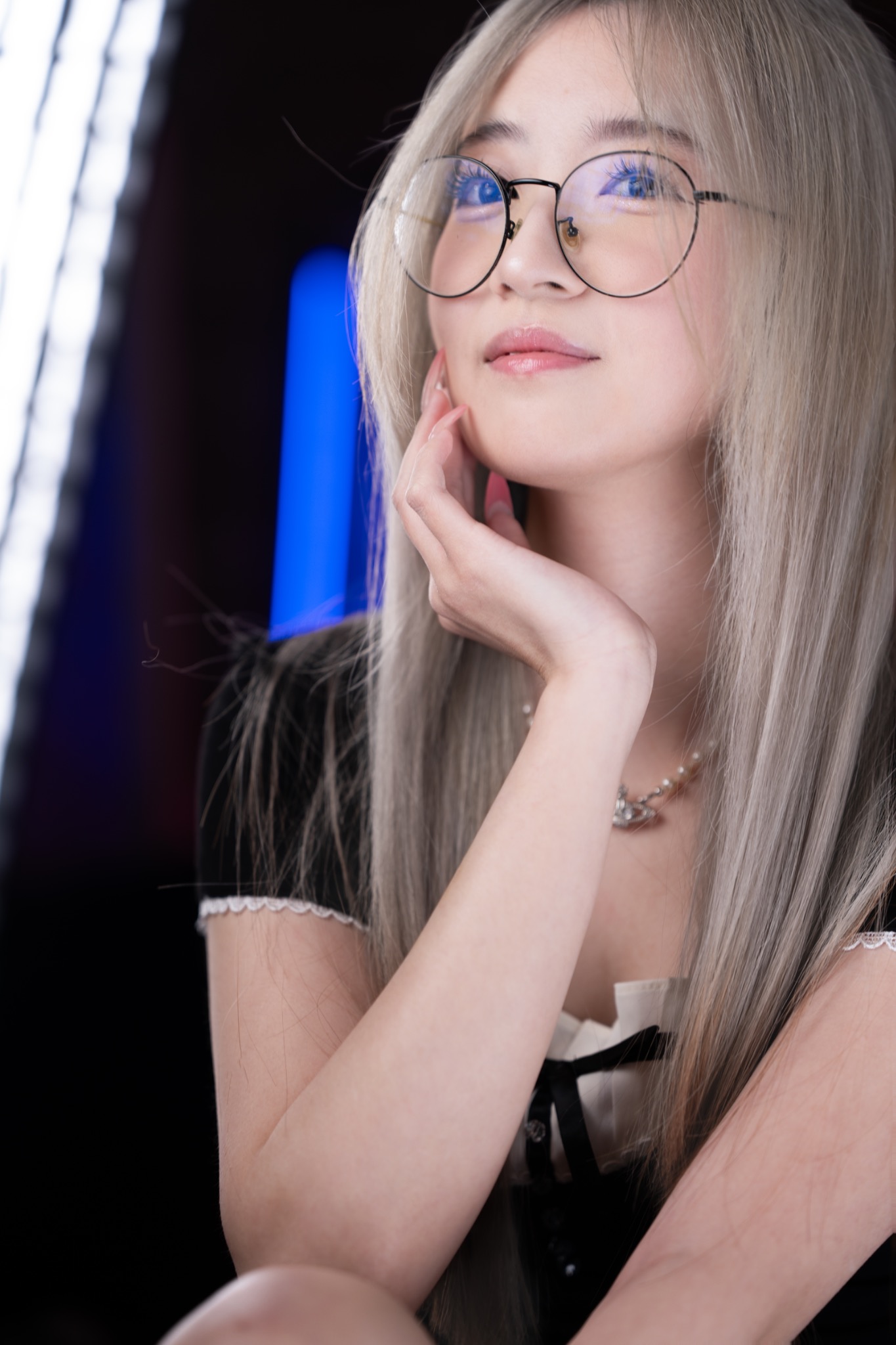 Kenn long silver hair with face-framing layers and glasses