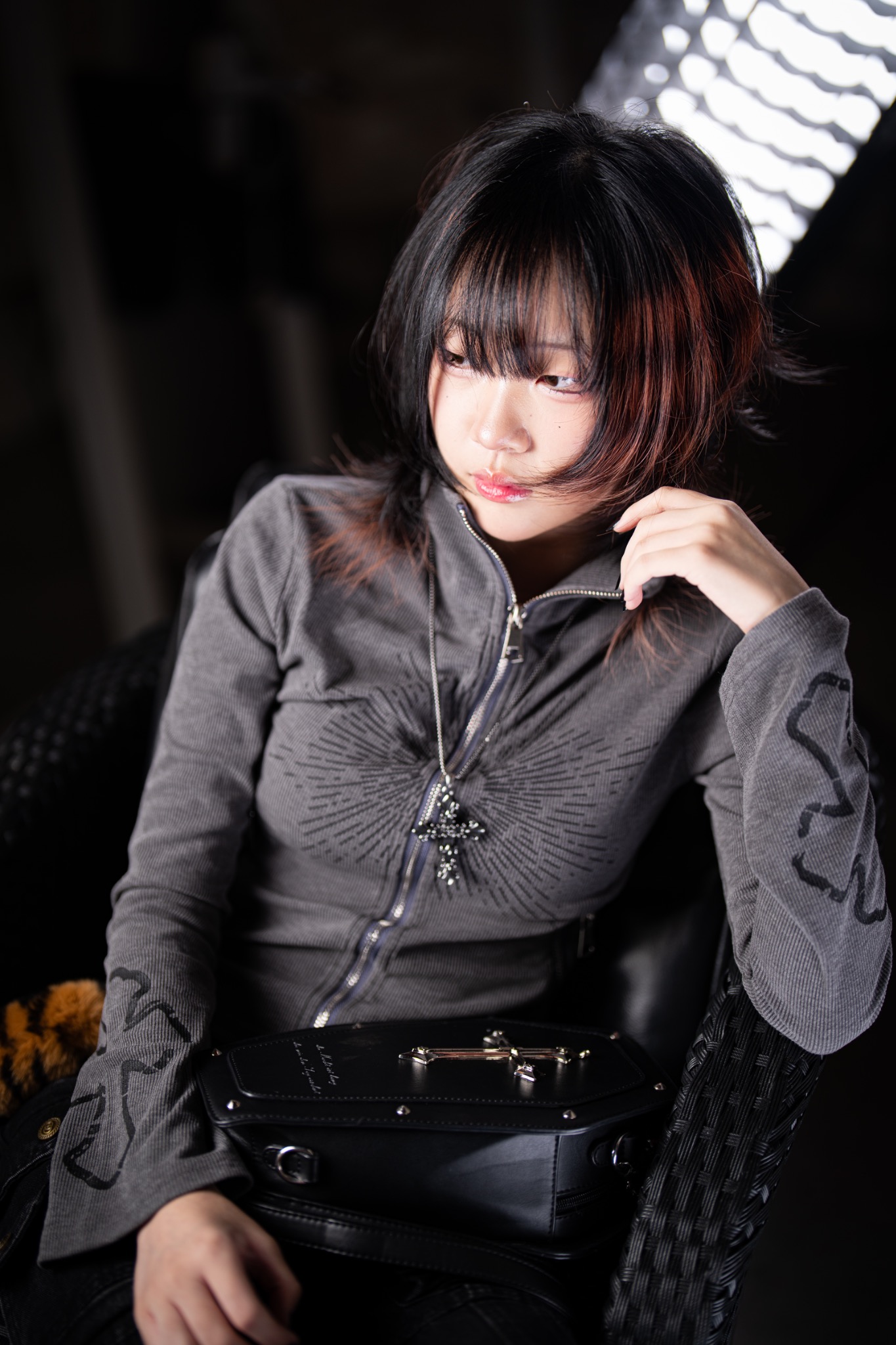 Rhea black layered haircut with warm red highlights
