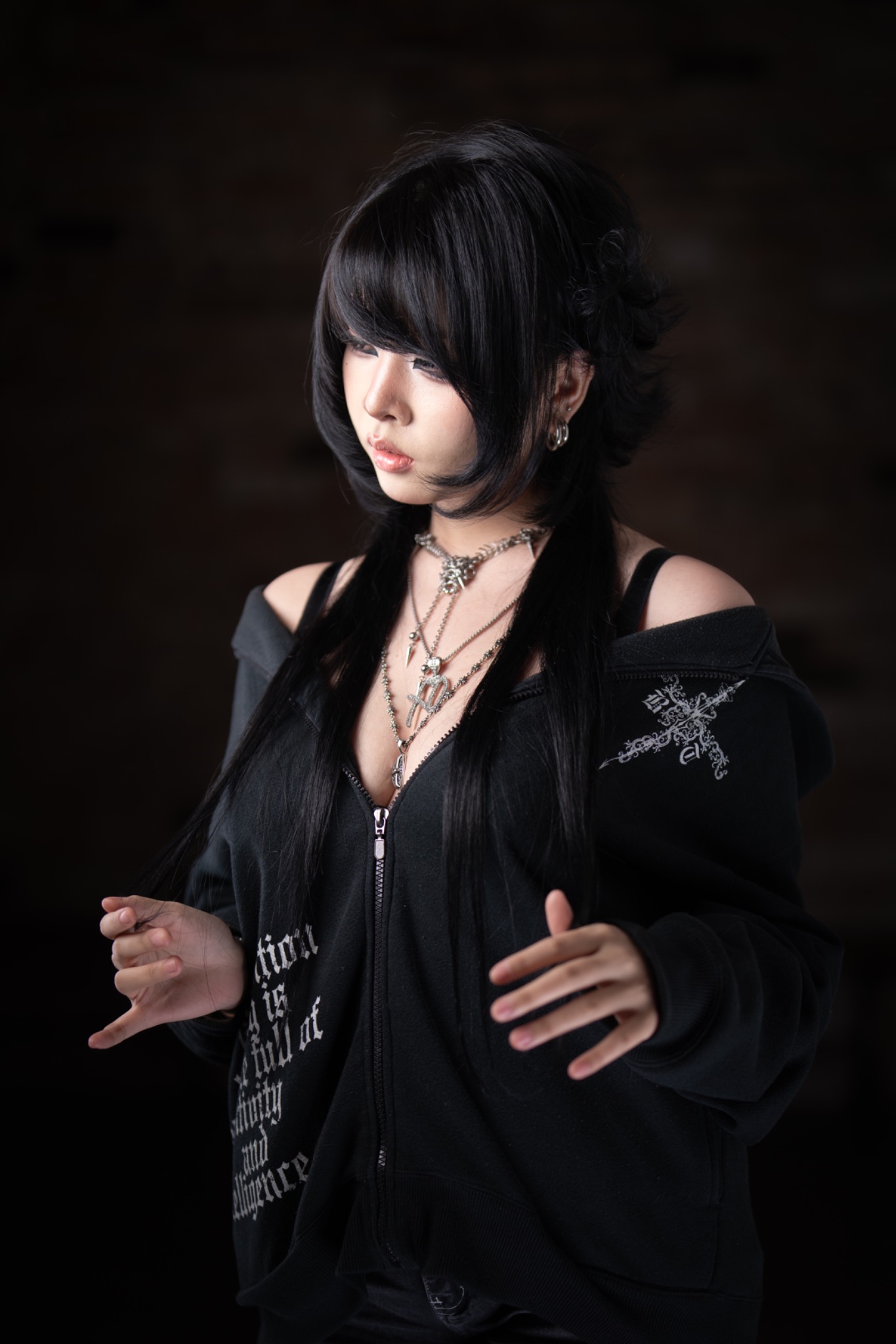 Rhea long black layered haircut with sculpted face framing, standing portrait